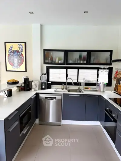Modern kitchen with sleek cabinetry, stainless steel appliances, and stylish decor in a contemporary home.