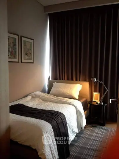Cozy bedroom with modern decor and soft lighting, perfect for relaxation and comfort.