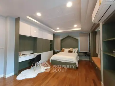 Spacious bedroom with modern design, featuring built-in storage and cozy lighting.