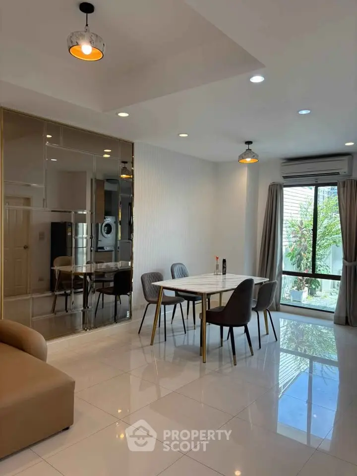 Modern dining area with elegant decor and large windows offering natural light.