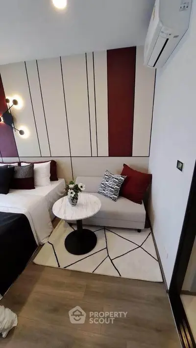 Stylish modern bedroom with elegant decor and cozy seating area, perfect for relaxation.