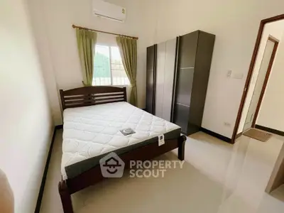 Cozy bedroom with modern furniture and natural light, perfect for relaxation.