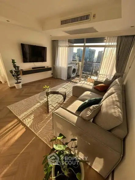 Modern living room with city view, stylish furniture, and natural light.