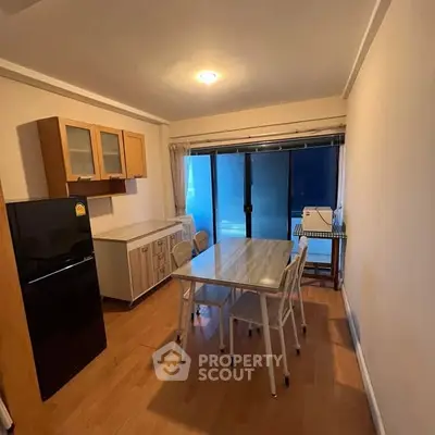 Cozy kitchen with dining area and modern appliances in a bright apartment.
