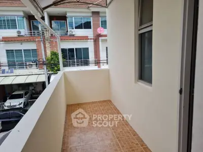 Spacious balcony with tiled flooring and street view, perfect for relaxation.