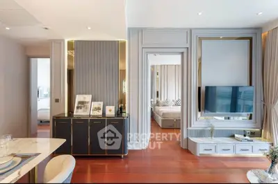 Elegant apartment interior with rich wooden flooring, modern furniture, and a sophisticated neutral color palette, offering a seamless flow between living spaces.