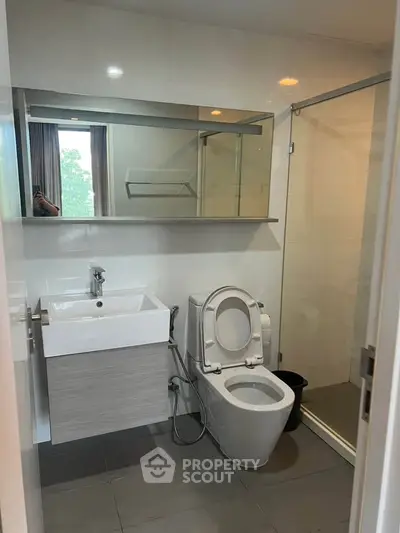 Modern bathroom with sleek fixtures and glass shower enclosure