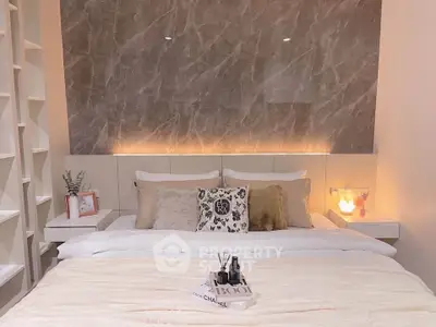 Luxurious bedroom with elegant marble accent wall and cozy lighting