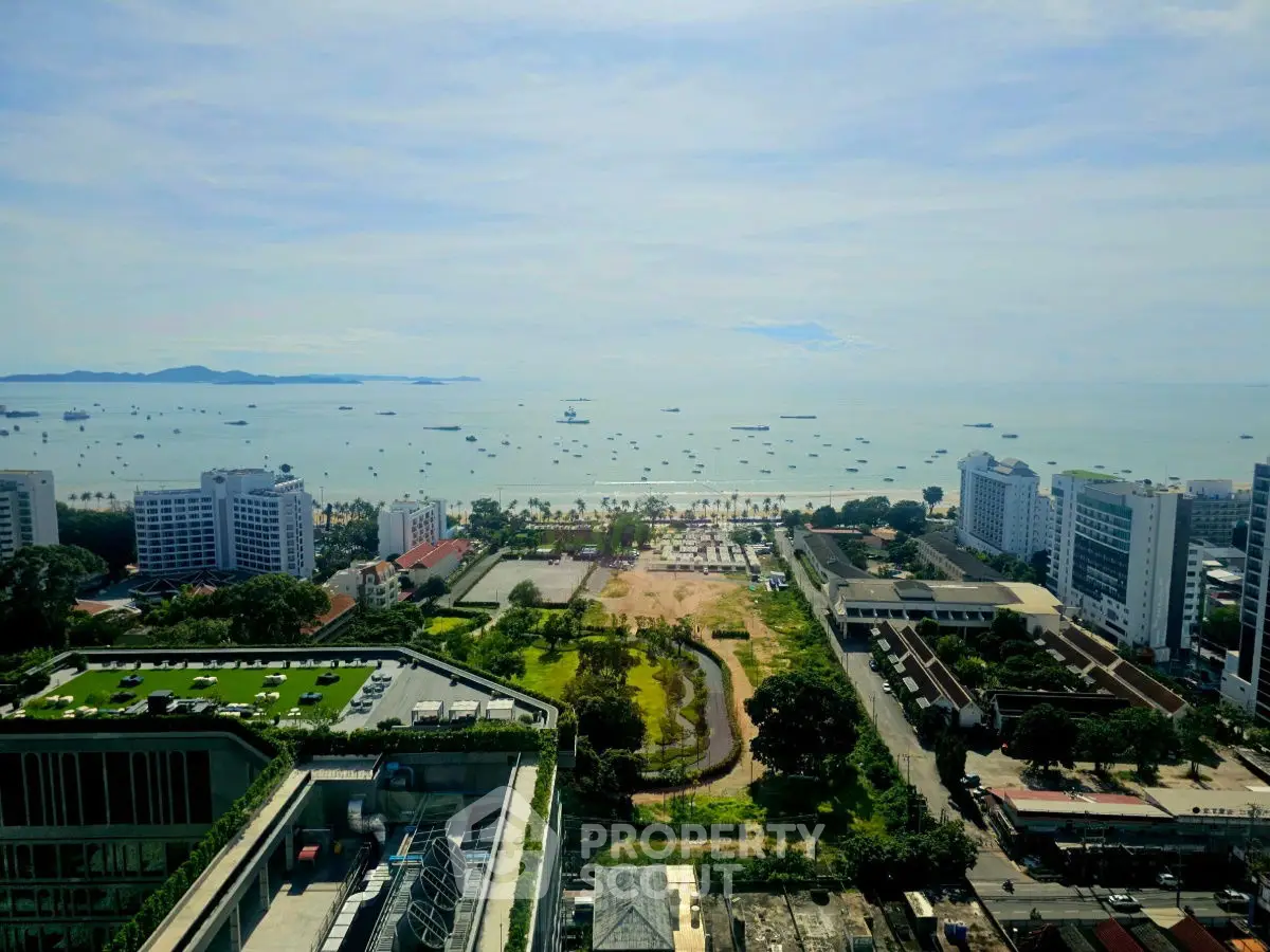 Stunning ocean view from high-rise building overlooking cityscape and coastline.