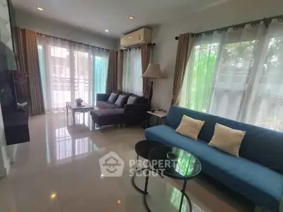 Spacious living room with modern furniture and large windows offering natural light.