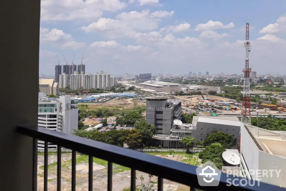 Stunning cityscape view from a high-rise balcony overlooking urban development and skyline.