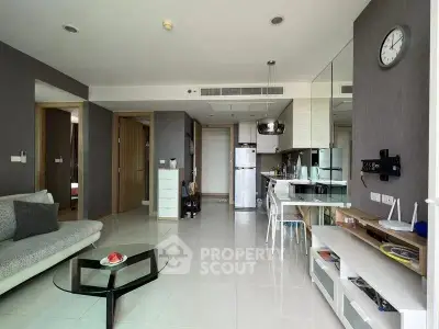 Modern open-layout living room with sleek kitchen and stylish decor
