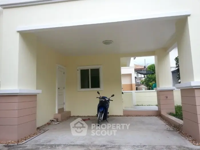 Charming covered parking area with a motorbike, perfect for urban living.