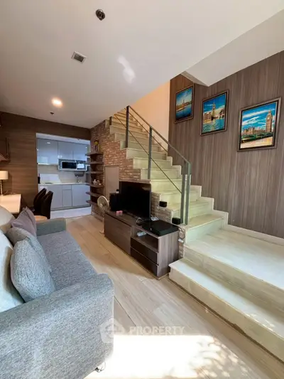 Modern living room with stylish staircase and cozy seating area
