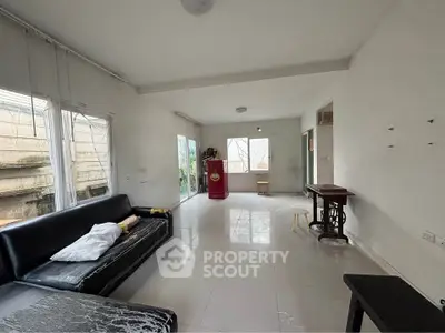 Spacious living room with large windows and minimalist decor