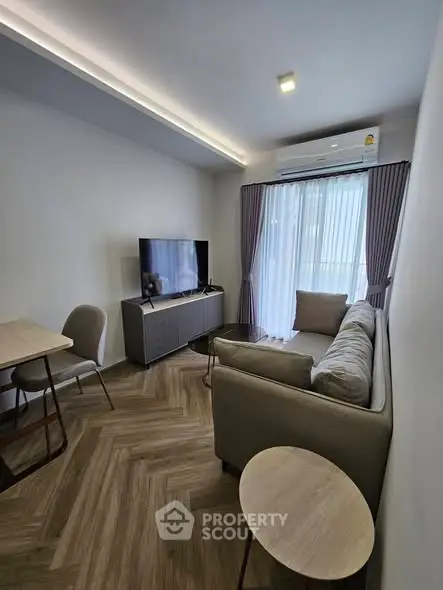 Modern living room with sleek furniture and natural light, perfect for cozy relaxation.