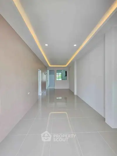 Spacious modern living room with sleek tile flooring and recessed lighting