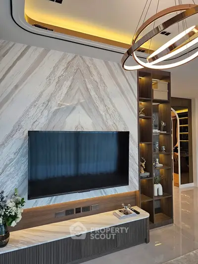 Luxurious living room with modern TV setup and elegant lighting