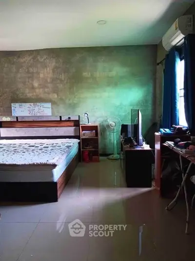 Spacious bedroom with modern decor and natural light