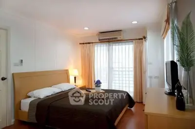 Spacious bedroom with modern decor and natural light