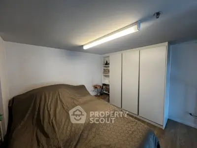 Cozy bedroom with modern lighting and ample storage space