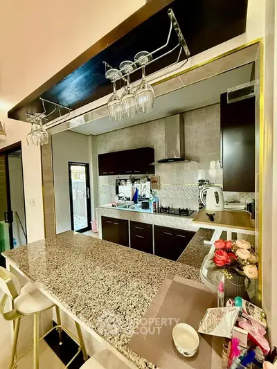 Modern kitchen with granite countertop and open layout design