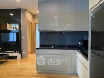 Modern kitchen with sleek cabinetry and open layout in stylish apartment