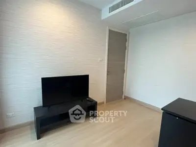 Modern minimalist living room with sleek TV stand and wooden flooring