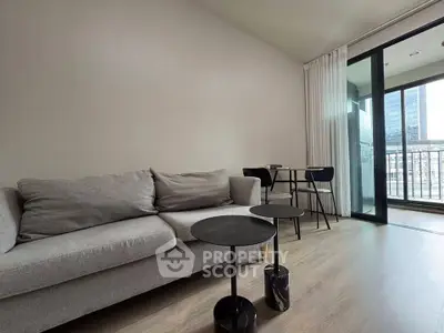 Modern living room with sleek furniture and balcony view in urban apartment