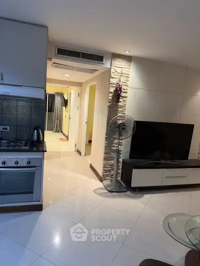 Modern open-layout living room with sleek kitchen and stylish decor