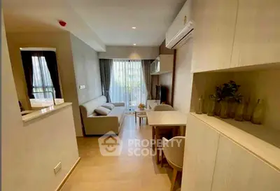 Modern living room with cozy seating and natural light, perfect for relaxation and entertainment.