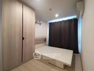 Modern minimalist bedroom with built-in wardrobe and sleek design.