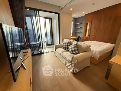 Modern studio apartment with balcony and city view, featuring cozy living area and stylish decor.