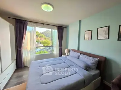 Cozy bedroom with scenic window view and modern decor