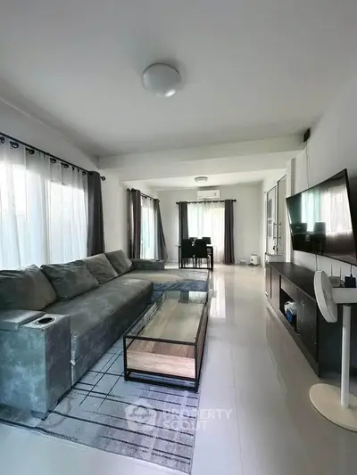 Spacious modern living room with large windows and stylish furniture