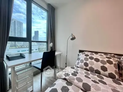 Modern bedroom with city view, featuring a cozy bed and study desk by the window.