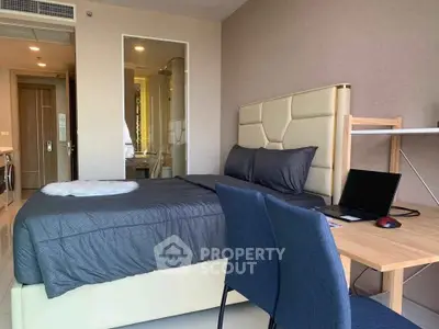 Modern bedroom with stylish decor and workspace in a contemporary apartment.