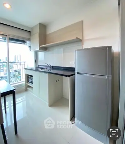 Modern kitchen with sleek appliances and city view, perfect for urban living.
