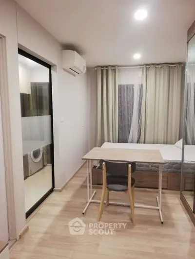 Modern bedroom with study area and air conditioning in cozy apartment