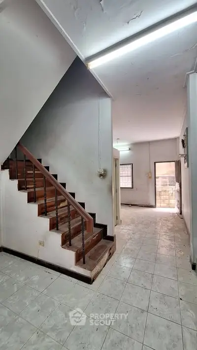 Spacious interior with staircase and tiled flooring in a residential property