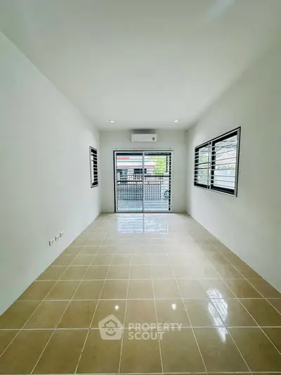 Spacious unfurnished room with large windows and tiled floor, perfect for customization.