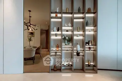 Luxurious modern interior with elegant shelving and dining area, showcasing sophisticated design and decor.