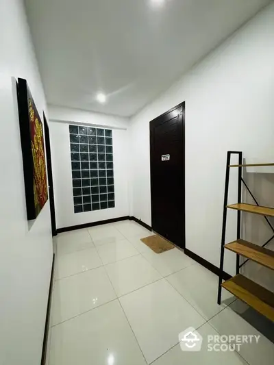 Modern hallway with sleek design and glass block accent wall