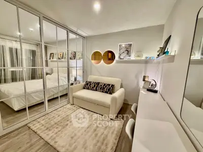 Chic bedroom with mirrored closet and cozy seating area