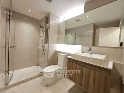 Modern bathroom with sleek fixtures and spacious shower area