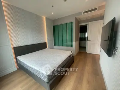 Modern bedroom with stylish decor and ensuite bathroom in a luxury apartment.