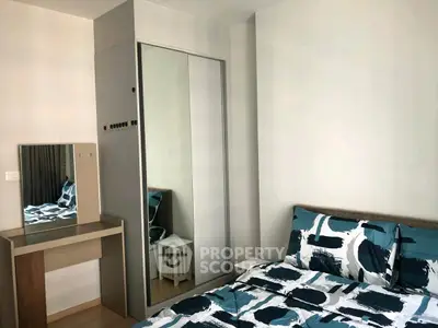 Modern bedroom with stylish bedding and mirrored wardrobe in a cozy apartment.