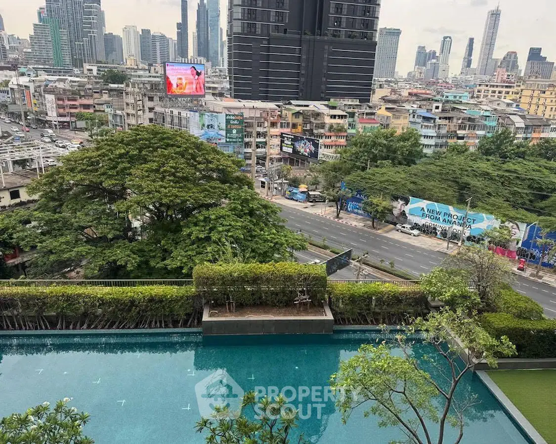Stunning cityscape view from rooftop pool in urban high-rise building.