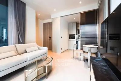 Modern living room with sleek furniture and open kitchen layout in luxury apartment.