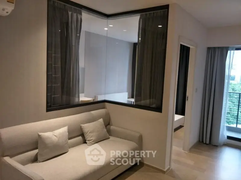 Modern living room with sleek design and large window offering natural light